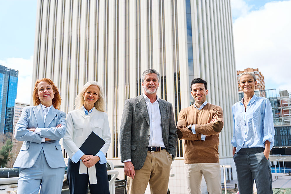 Business people standing proud and looking at camera in a financial district