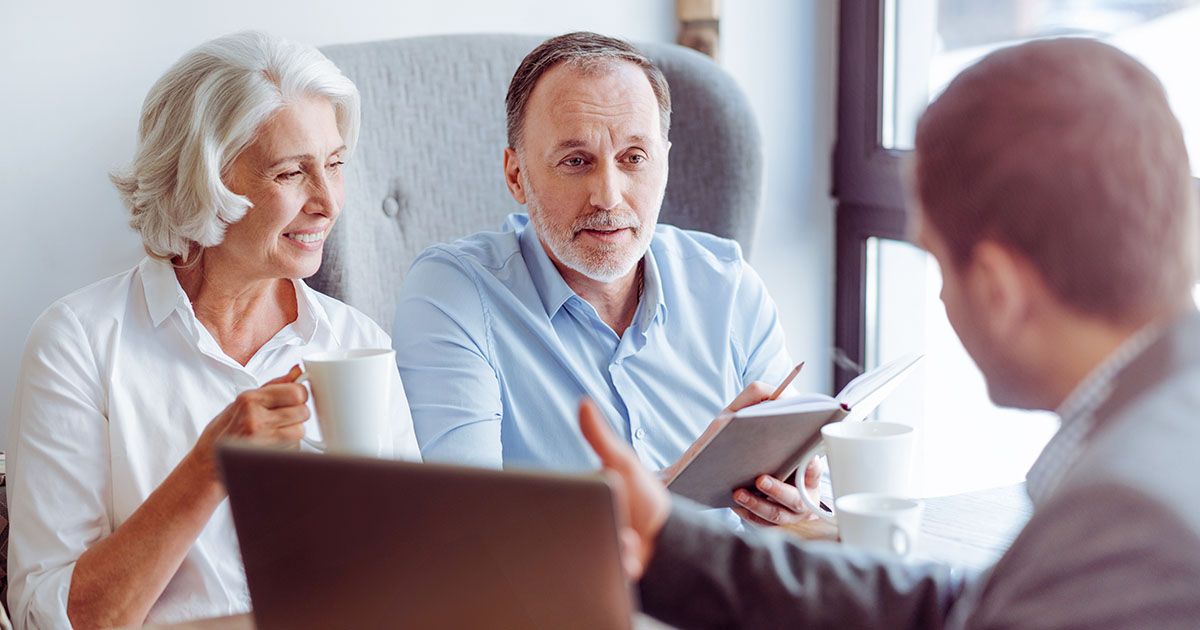 Retired couple talking with tax advisor about charitable giving strategies