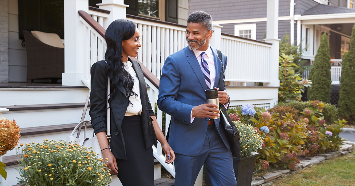 Business couple leaving house to commute to work